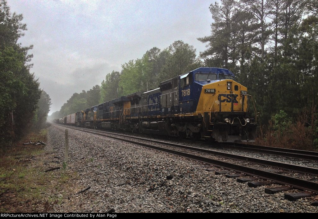 CSX C40-8W 7818, ES44AC-H 3176, ES40DC 5354, and AC44CW 54 wait for green in the pouring rain